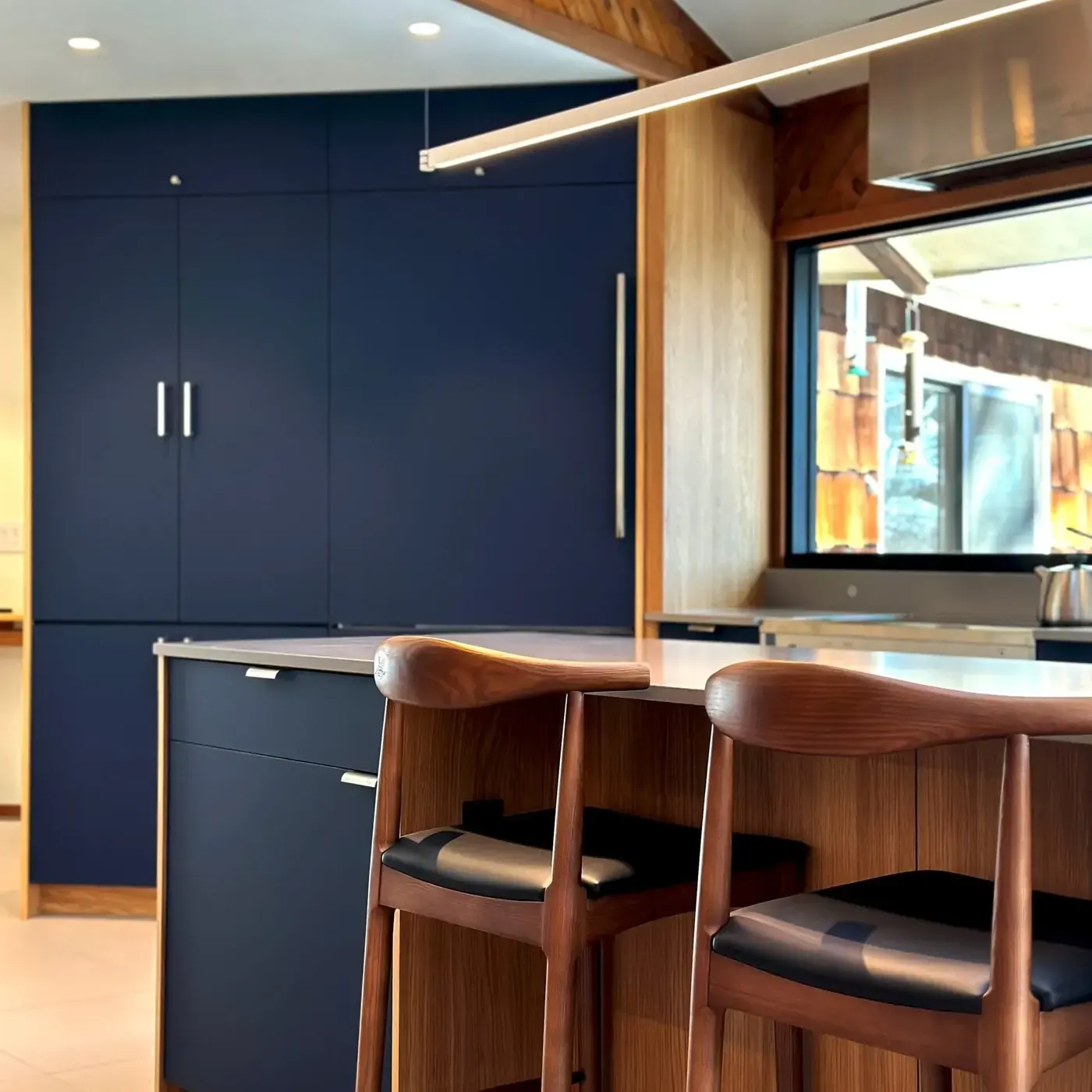 Painted blue cabinets with white oak in a Hudson Valley kitchen remodel by Timber Design + Build