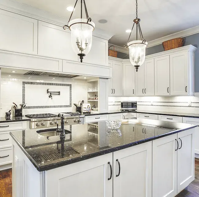 White kitchen cabinetry with crown molding to the ceiling by Timber Design + Build